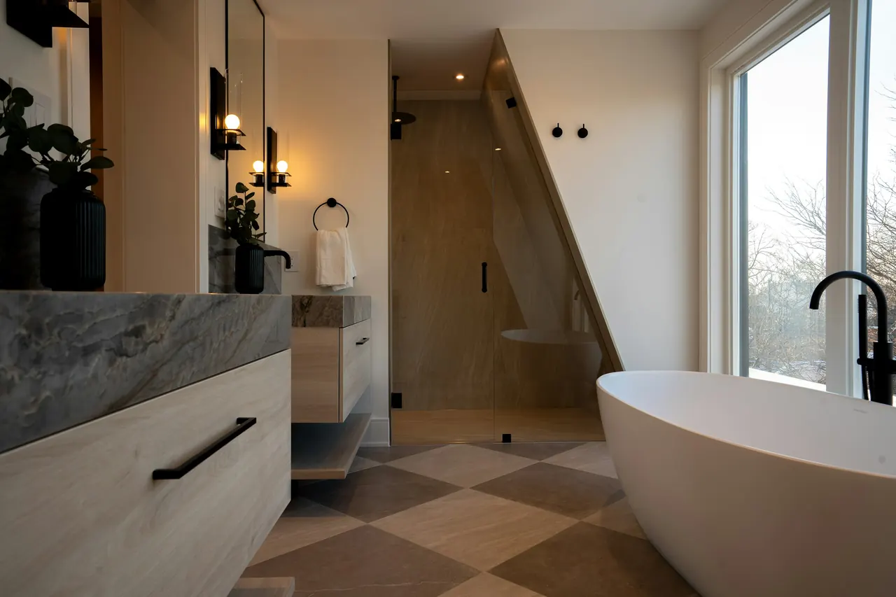 Finished bathroom with a stone-topped vanity, a tiled walk-in shower and a freestanding bath